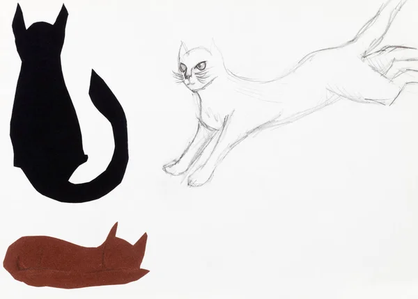 Gato saltando e duas figuras de gato cortadas de papel — Fotografia de Stock