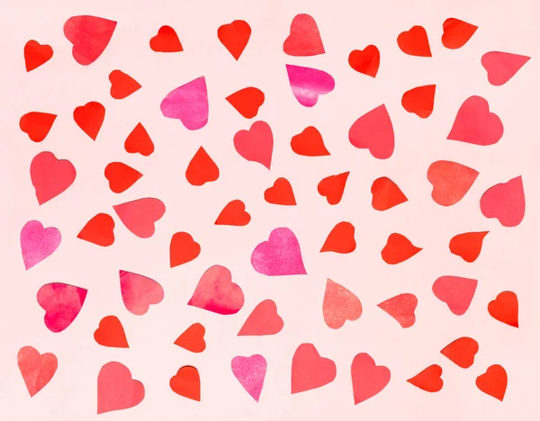Hearts cut from color papers on pink pastel paper — Stock Photo, Image