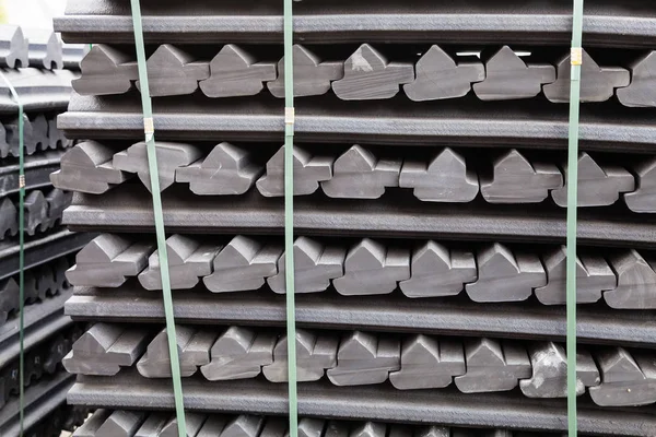 Stockpiles of gray rubber retainers for rails — Stock Photo, Image