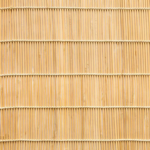 Square background of wooden mat woven from sticks — Stock Photo, Image