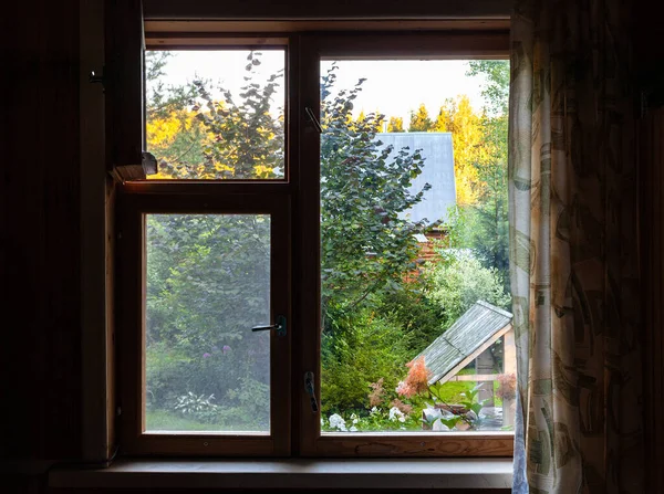 夏の日没に田舎の家の窓からよく見える緑の裏庭の景色 — ストック写真