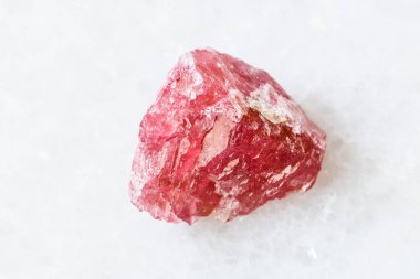 closeup of sample of natural mineral from geological collection - unpolished Rhodonite crystal on white marble background from Morro da Mina mine, Conselheiro Lafaiete, Minas Gerais, Brazil clipart