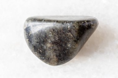 Beyaz mermer arka planda cilalanmış diorit kaya örneği Rusya, Karelia 'dan yakın plan