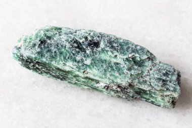 sample of raw green kyanite mineral on white marble background close up from Madagascar