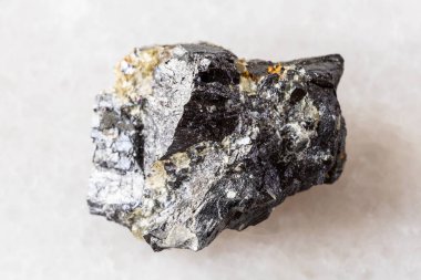 sample of rough wolframite mineral on white marble background close up from Altai, Russia