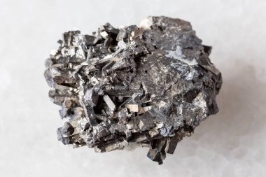 sample of rough arsenopyrite mineral on white marble background close up from Primorye, Russia