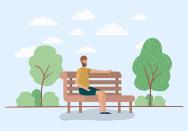 Park sandalyede oturan genç adam