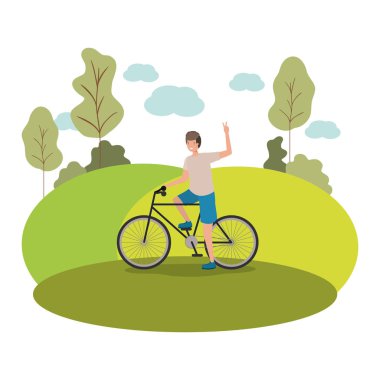 Parkta bisiklet sporu yapan genç adam.