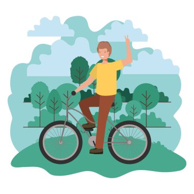 Parkta bisiklet sporu yapan genç adam.