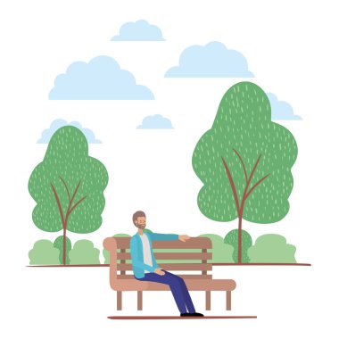 sakallı genç adam parkta sandalyede oturuyor