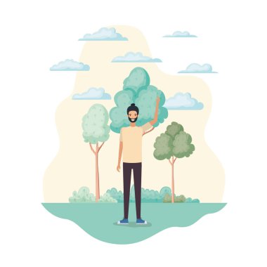 Genç adam ağaçlar ve bitkilerle manzarada