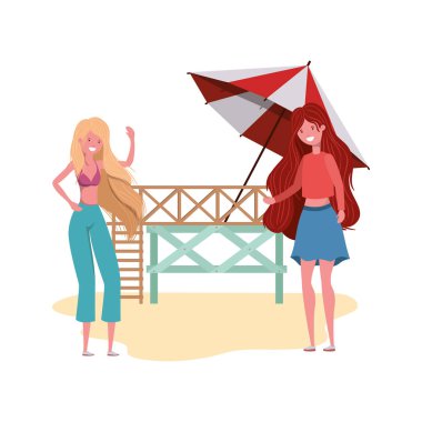 Kadınlar ellerinde şemsiyeyle sahilde duruyorlar.