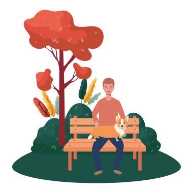 Genç adam parkta sevimli bir köpeği kaldırıyor.