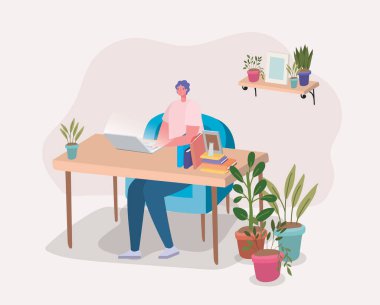 Masa tasarımında dizüstü bilgisayarla çalışan adam