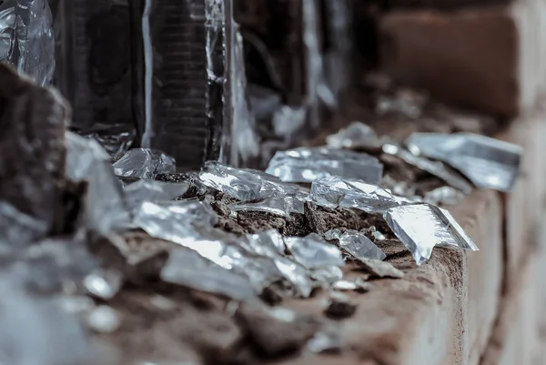 Smashed window in a brick building