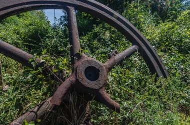 overgrown old big wheel of iron