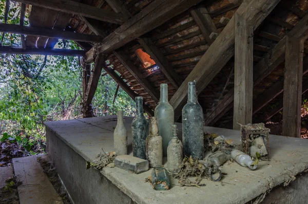 Different bottles in old house — Stock Photo, Image