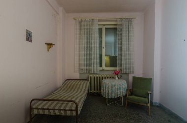 Hastalık odası, hastane masası ve çiçekleri.