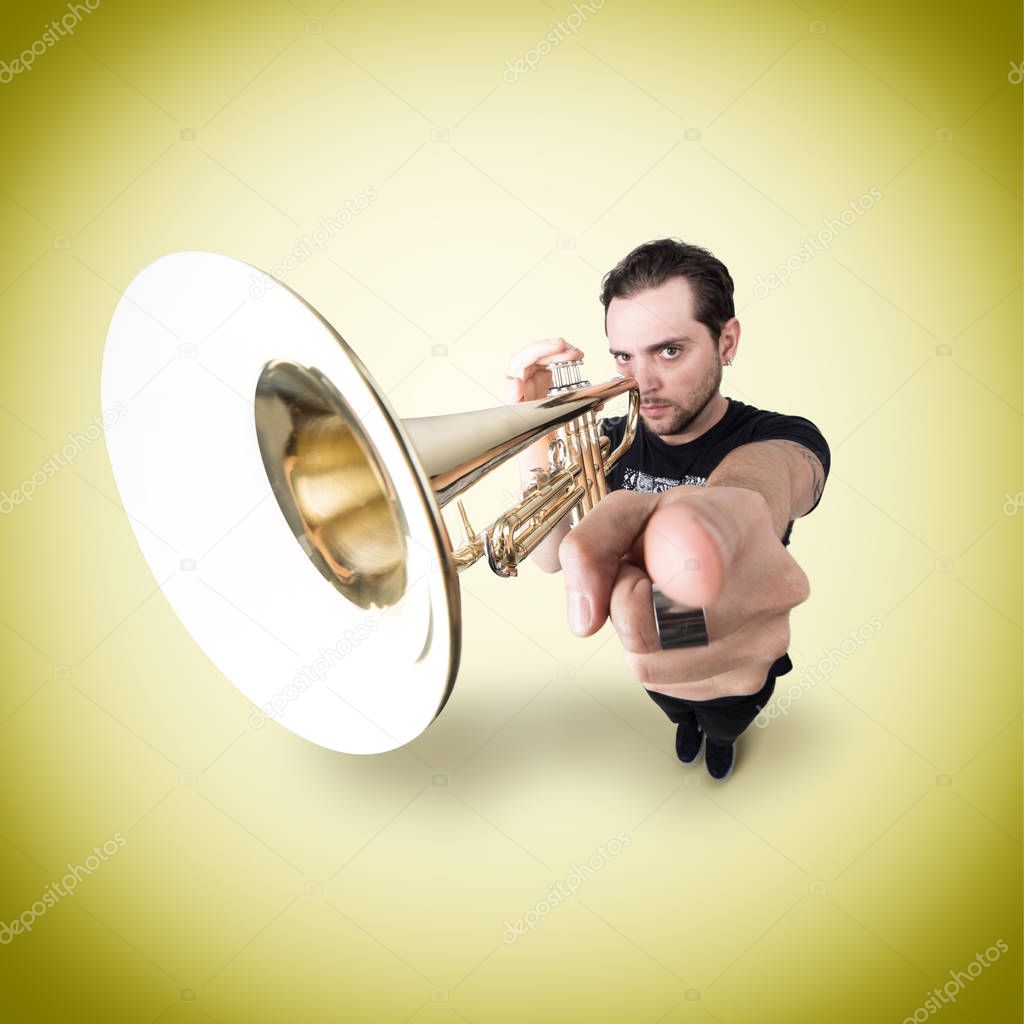 Funny man is playing trumpet pointing finger at Camera