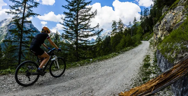 Mountain biking couple with bikes on track, Cortina d\'Ampezzo, Dolomites, Italy