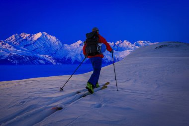 Skitouring  at sunrise with amazing view of swiss famous mountains in beautiful winter powder snow of Alps.  clipart