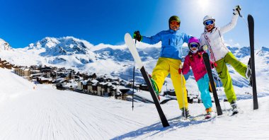 Mutlu bir aile dağlarda kış tatilinin tadını çıkarıyor Val Thorens, 3 vadi, Fransa. Yüksek dağlarda kar ve güneşle oynamak. Kış tatili.