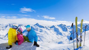 Happy family enjoying winter vacations in mountains, Val Thorens, 3 Valleys, France. Playing with snow and sun in high mountains. Winter holidays. clipart