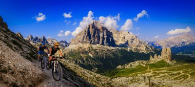 Kadın ve motosiklet Dolomites dağlar manzarada kişini Bisiklete binme. Çift MTB enduro iz parça Bisiklete binme. Açık spor aktivitesi.
