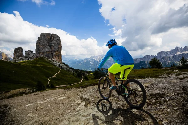 Tourist cycling in Cortina d 'Ampezzo, stunning Cinque Torri and — стоковое фото