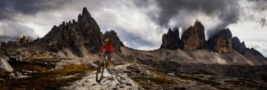 Bisiklete binme kadın ve motosiklet Dolomites dağlarda kişini ve