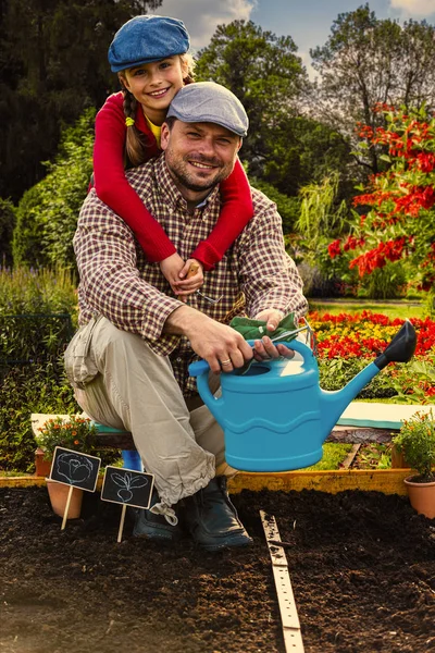 Beatifull girl with father in the garden at summer day. Child re — Stock Photo, Image