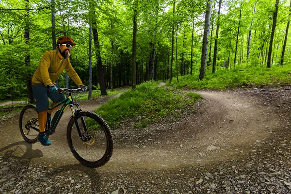 Mountain biker riding on bike in spring mountains forest landsca — Stock Photo, Image