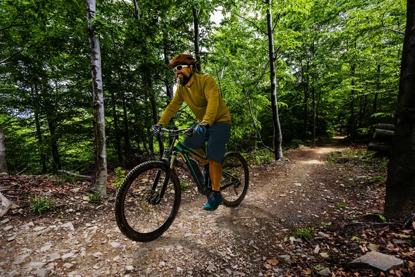 Radler auf dem Fahrrad bei Sonnenuntergang Berge Waldlandschaft. — Stockfoto