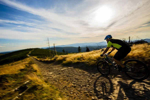 Cycling man riding on bike at sunset mountains forest landscape. — Stock Photo, Image