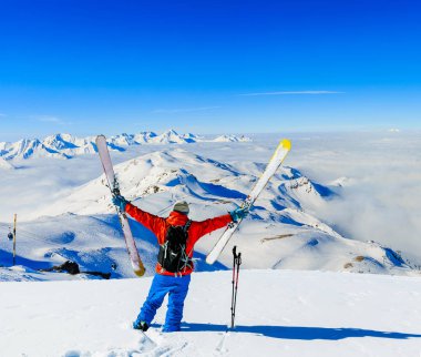 Ski in winter season, mountains and ski touring man on the top i clipart