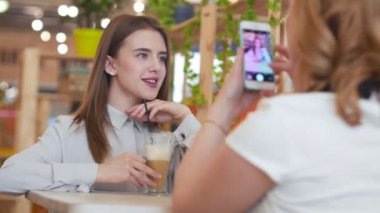 Kadın alarak fotoğraf onun arkadaşı telefon kamera.