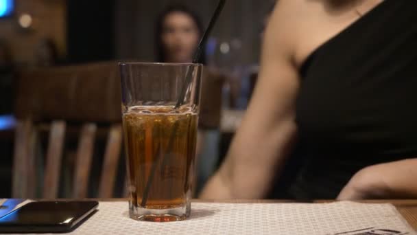 Glass of cocktail on the table foreground. — Stock Video