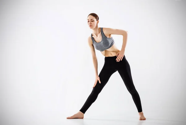 Woman making yoga belly breathing exercises. Full length.