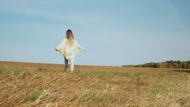 Gelukkig lachende jonge vrouw genieten van de natuur op het veld oogsten. — Stockvideo