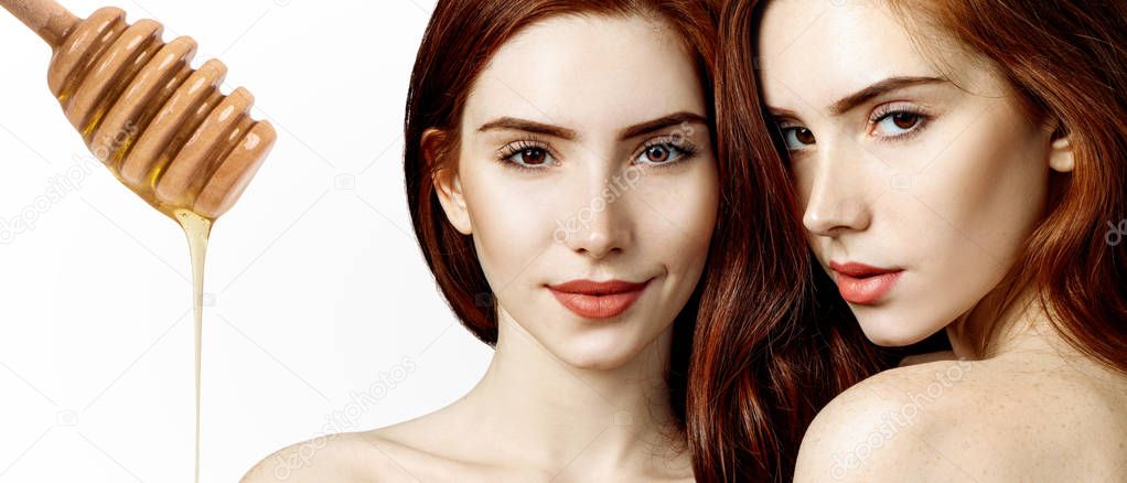 Young redhead woman and honey spoon prepare for facial mask.
