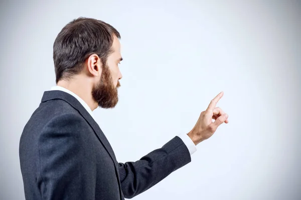 Businessman pointing to something or touching by forefinger. — Stock Photo, Image