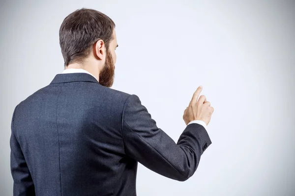Businessman pointing to something or touching by forefinger. — Stock Photo, Image