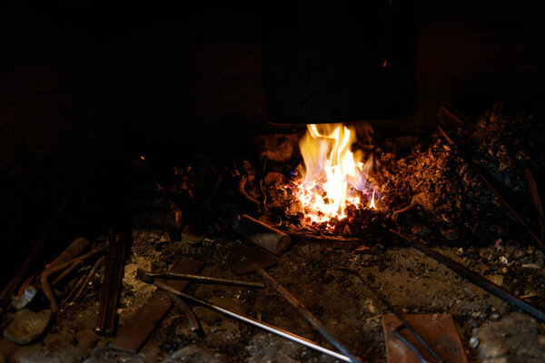 The fire in the furnace of the blacksmith.