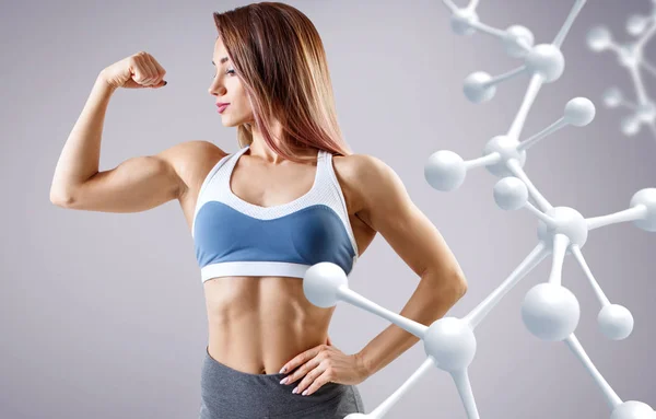 Sporty young woman posing near molecules structure. — Stock Photo, Image