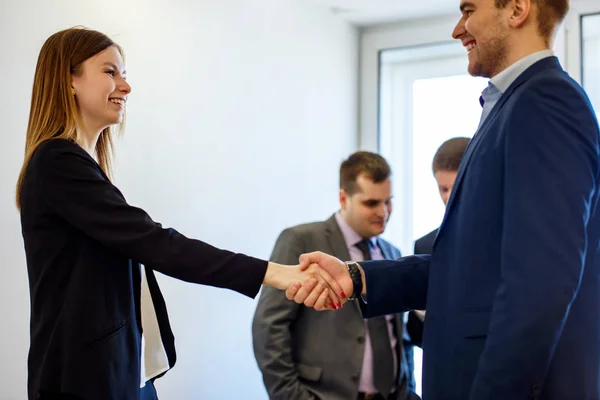 Young Business vrouw en man in formele dragen schudden handen foeground View. — Stockfoto