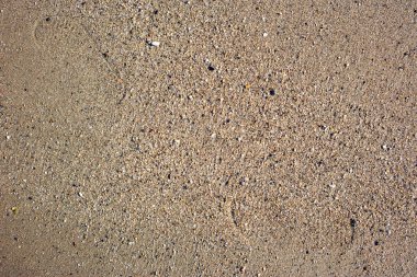 Deniz kenarı, doğal yüzeyin temiz kum dokusu üst görünümü.