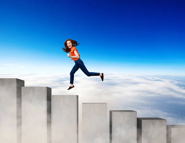 Young woman running up on the stairs blocks. — Stock Photo, Image