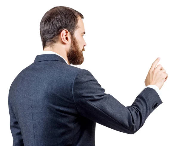 Businessman with beard pointing to something or touching by forefinger. — Stock Photo, Image