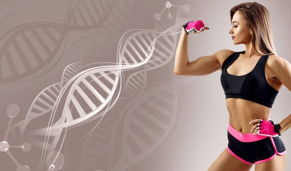 Athletic fitness woman standing among DNA chains. — Stock Photo, Image