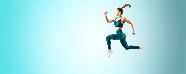 Young woman runner in blue sportswear jump in the air. — Stock Photo, Image